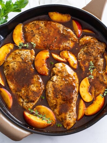 Peach Chicken in a skillet with Balsamic sauce and fresh thyme.