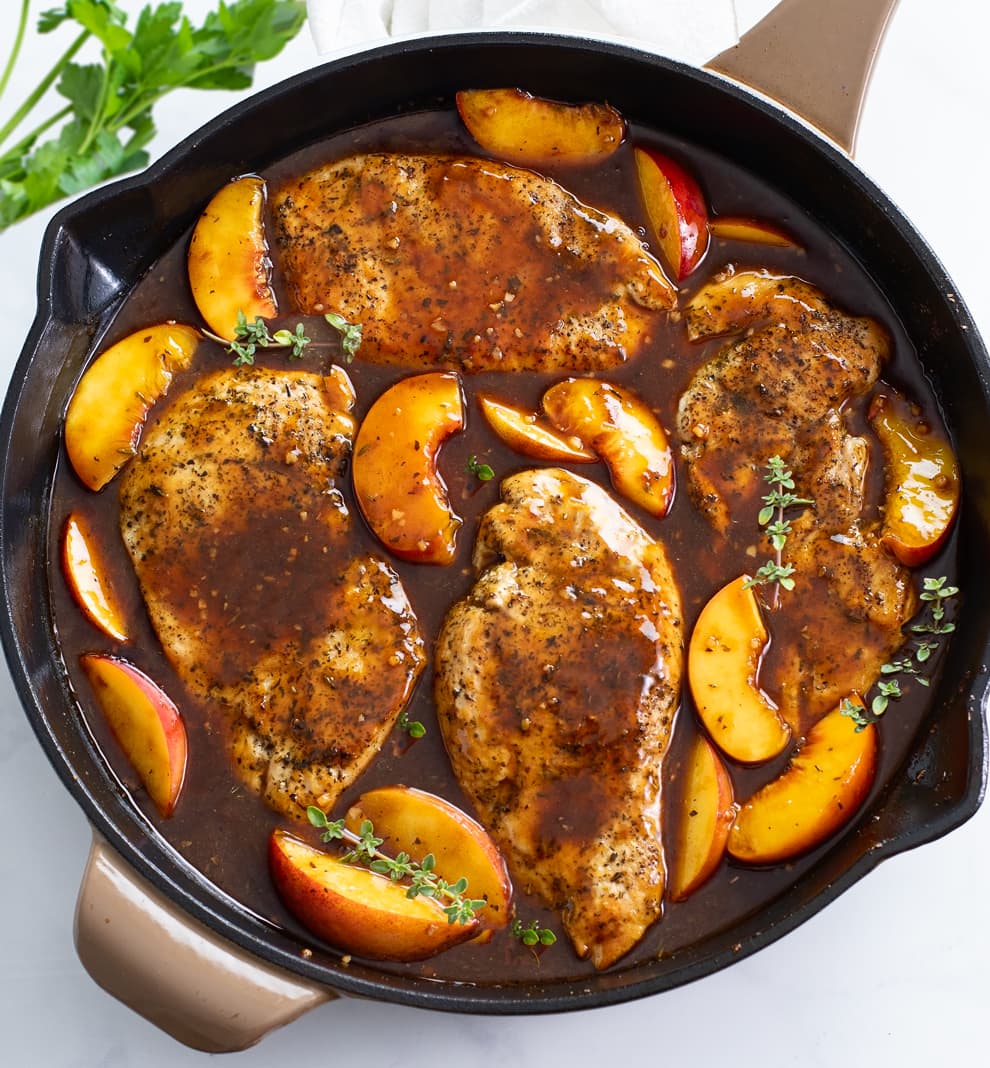 Peach Chicken in a skillet with Balsamic sauce and fresh thyme.