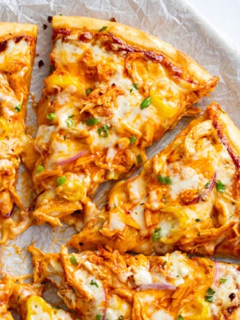 Slices of Buffalo Chicken Pizza with blue cheese and buffalo sauce.