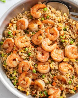 A skillet of Shrimp Fried Rice with shrimp, carrots, peas, and eggs.