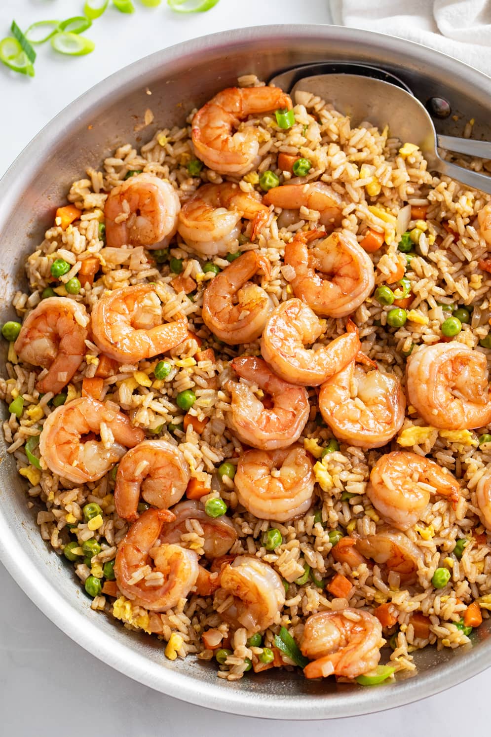 A skillet of Shrimp Fried Rice with brown sauce, eggs, and vegetables.