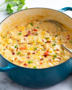 Chicken Corn Chowder in a blue soup pot with a ladle on the side.