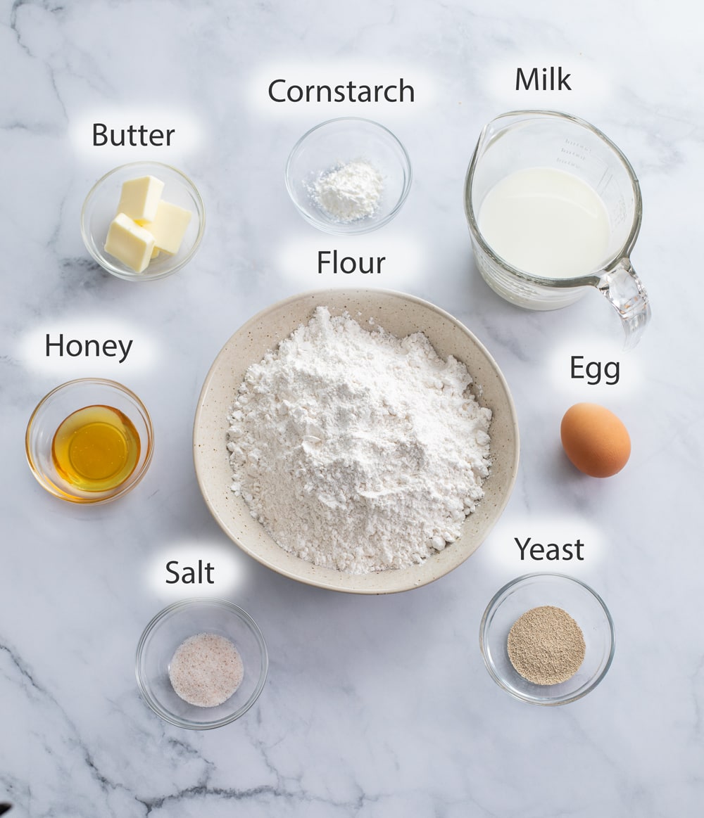 Ingredients for Dinner Rolls on a white surface with labels.