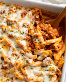 Ground Beef Casserole in a baking dish with a wooden spoon scooping it up.