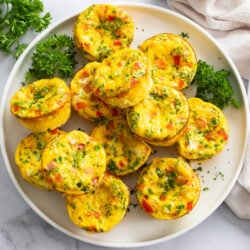 Egg Muffins on a white plate with parsley.