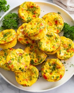 Egg Muffins on a white plate with parsley.