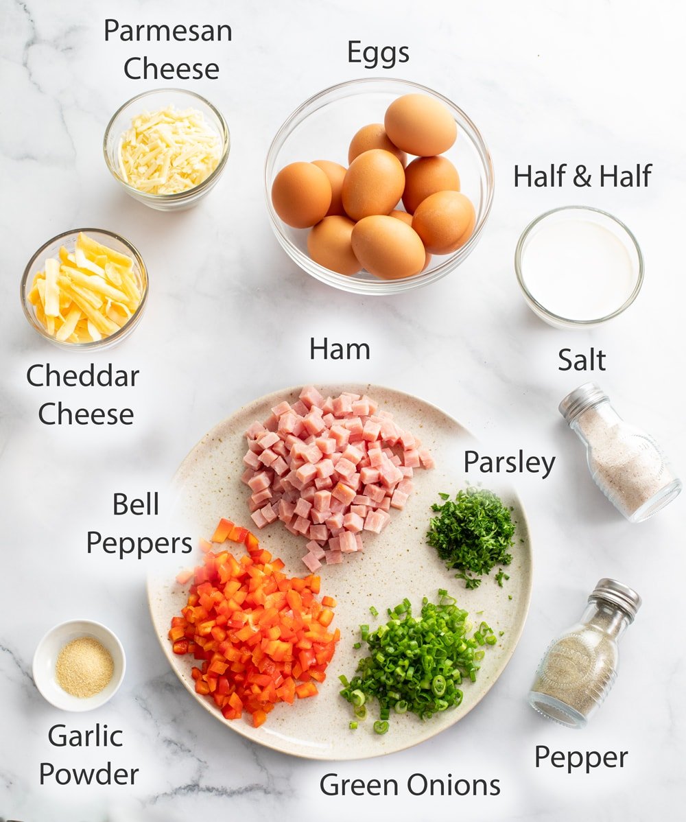 Ingredients for making Egg Muffins on a white surface with labels.