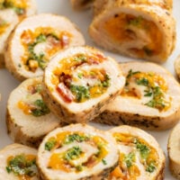 Chicken Roulade stacked on top of each other with cheese and broccoli in the middle.