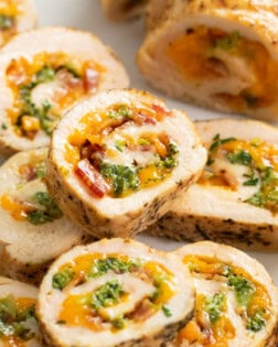 Chicken Roulade stacked on top of each other with cheese and broccoli in the middle.