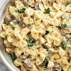 Mushroom Chicken Pasta in a skillet with creamy sauce and spinach.