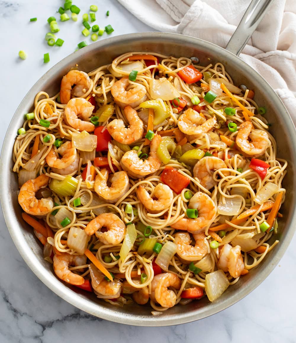 Shrimp Lo Mein with vegetables and sauce in a stainless steel skillet.