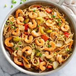 Shrimp Lo Mein in a skillet with sauce, vegetables, shrimp, and Lo Mein noodles.