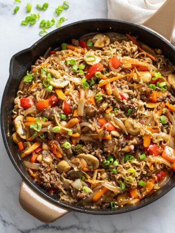 Beef Ramen Noodles in a skillet with ground beef, vegetables, and stir fry sauce.