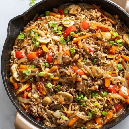 Beef Ramen Noodles in a skillet with ground beef, vegetables, and stir fry sauce.