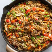 Beef Ramen Noodles in a skillet with stir fried vegetables, ground beef, and sauce.