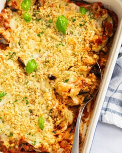 Eggplant Casserole in a baking dish with a spoon on the side.