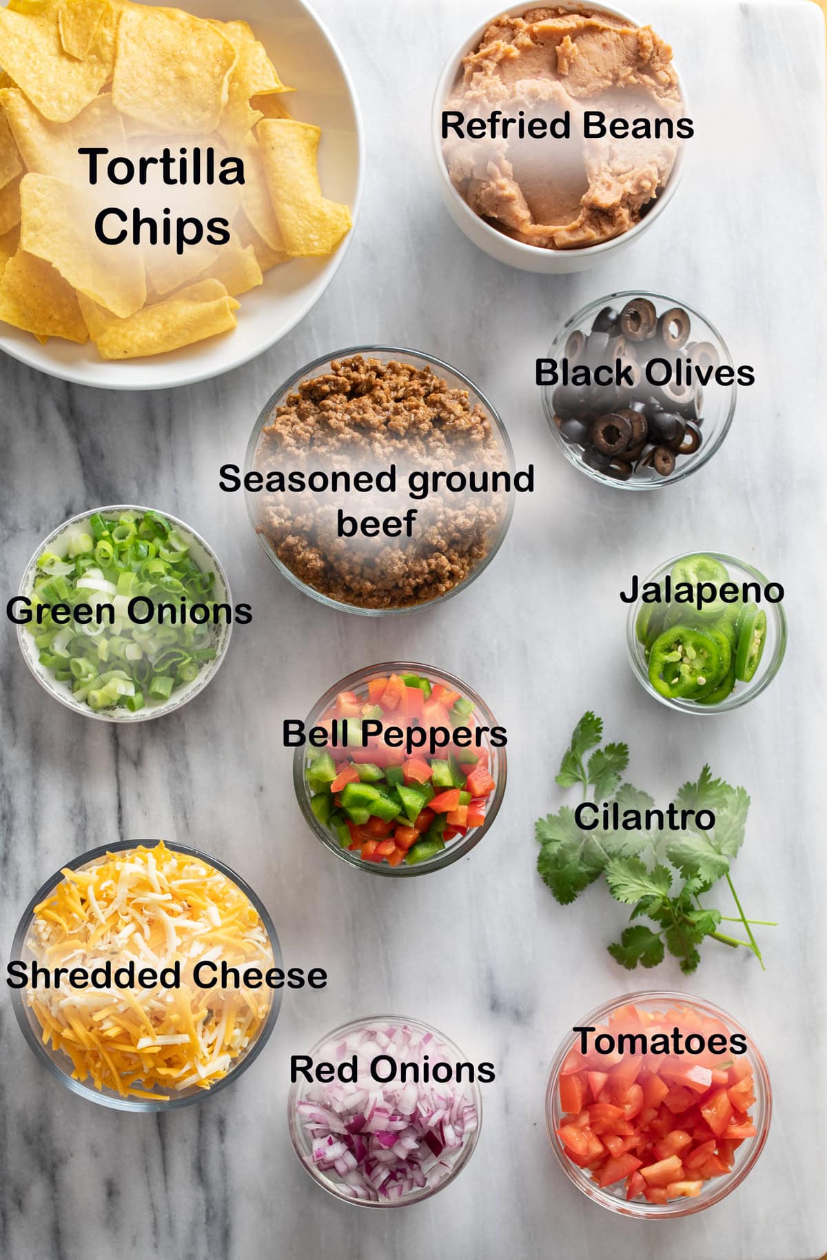 Overhead view of labeled ingredients needed to making Nachos.