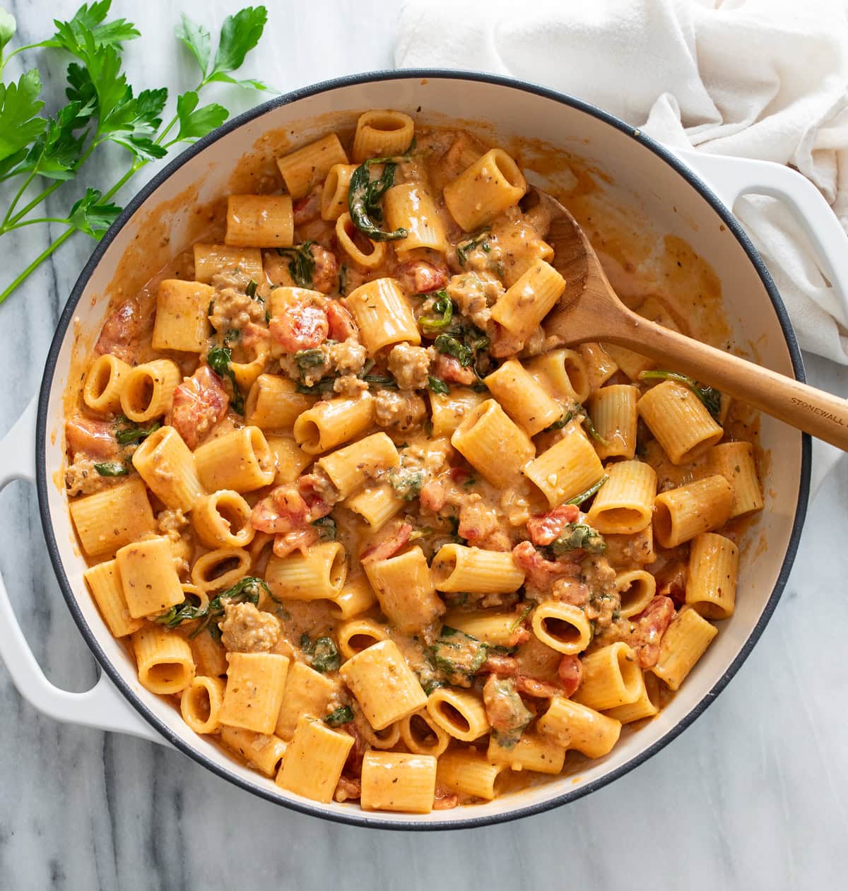 Tomato Spinach Pasta in a skillet with ground sausage, tomatoes, and spinach.