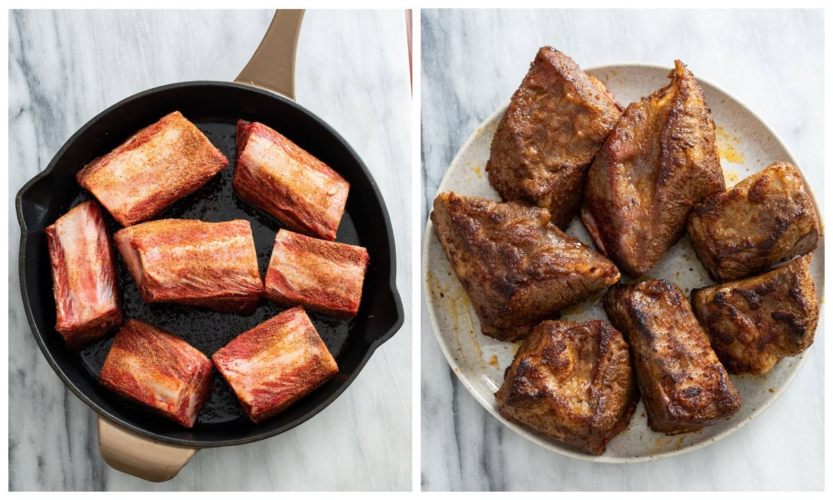 A skillet of uncooked short ribs next to a plate of seasoned and seared short ribs.