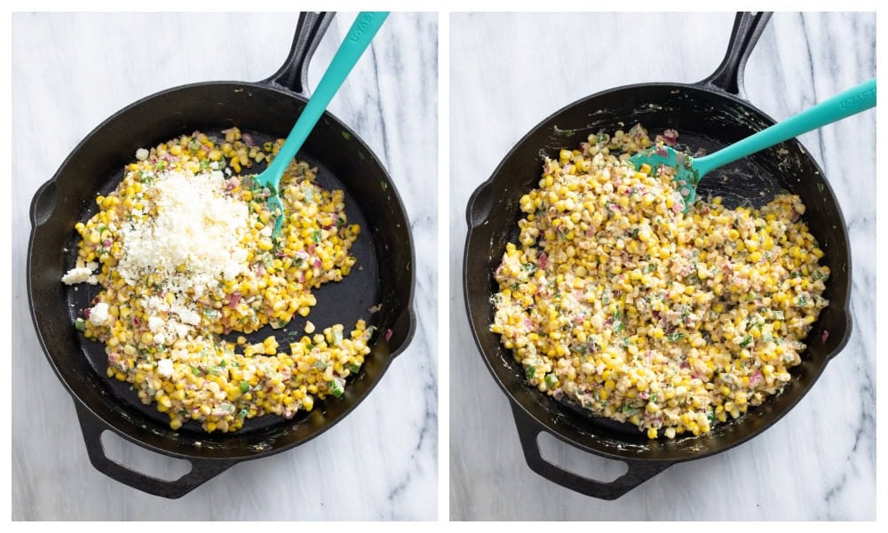 A cast iron skillet with cooked Mexican Street Corn Salad with Cotija cheese being added and mixed in.