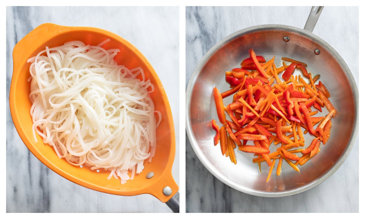 A colander with drained rice noodles next to a skillet with sliced red bell peppers and carrots.