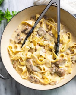 Truffle Pasta in a skillet with mushrooms and pappardelle tossed with a creamy Parmesan sauce.