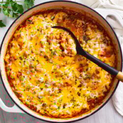 Unstuffed Peppers in a skillet with ground beef, sausage, rice, tomatoes, and cheese.