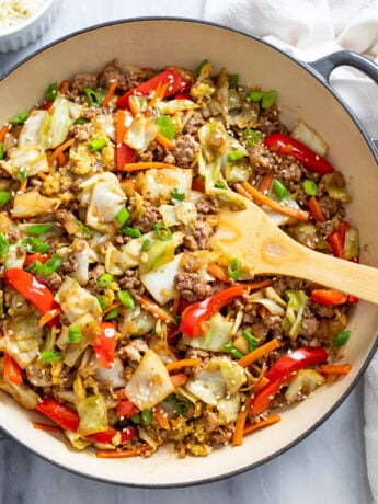 Cabbage Stir Fry in a skillet with vegetables, ground beef and pork, and a homemade sauce.