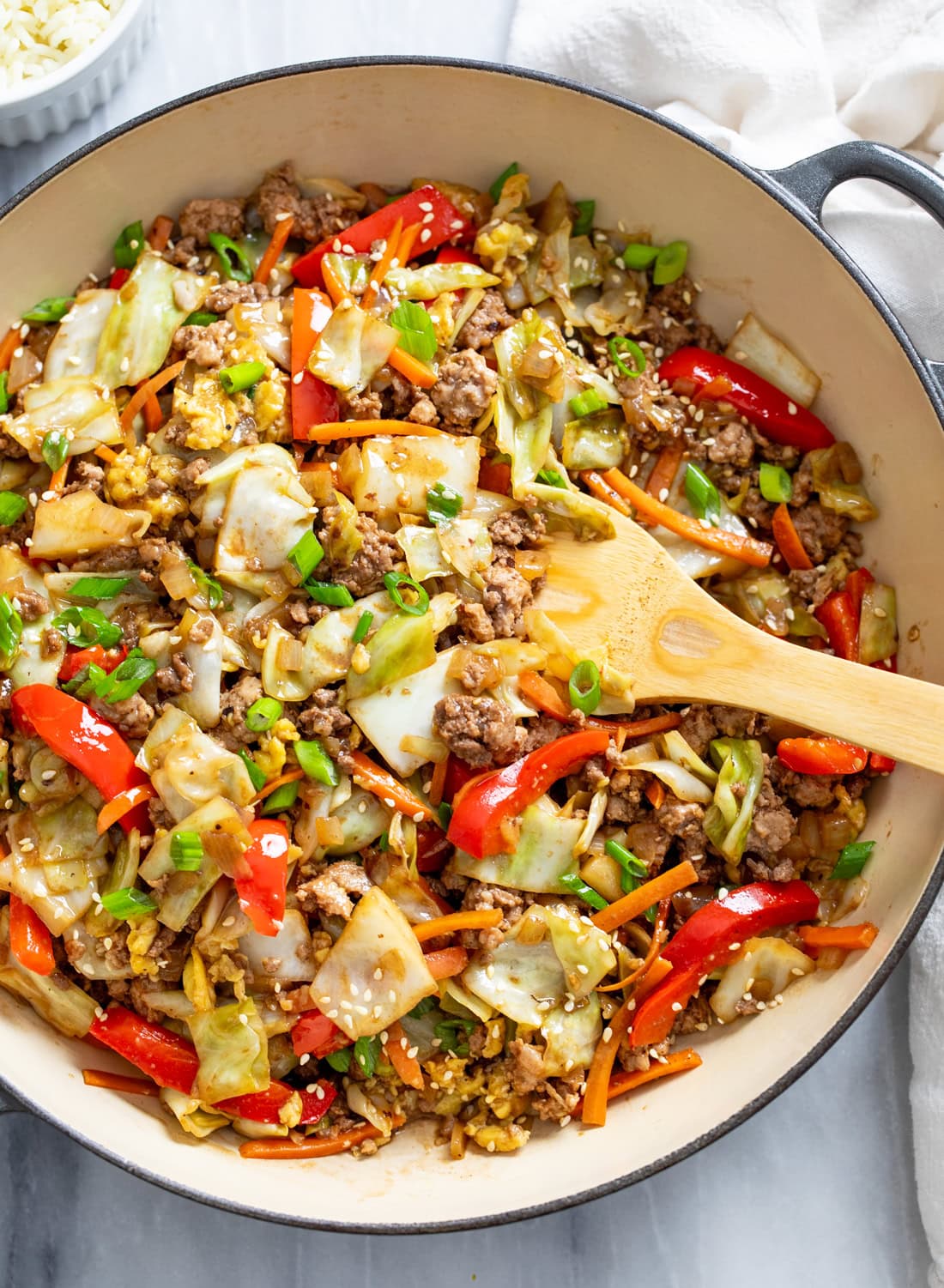 Cabbage Stir Fry in a skillet with vegetables, ground beef and pork, and a homemade sauce.