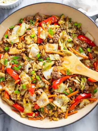 Cabbage Stir Fry in a skillet with vegetables, ground beef and pork, and a homemade sauce.